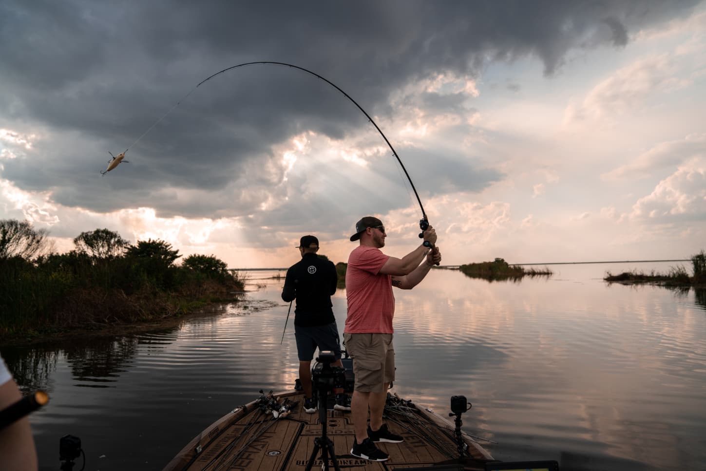 Anglers casting at sunset on the water